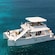 A group of people engaged in recreational activities on an electric catamaran and a raft at Bonaire National Marine Park